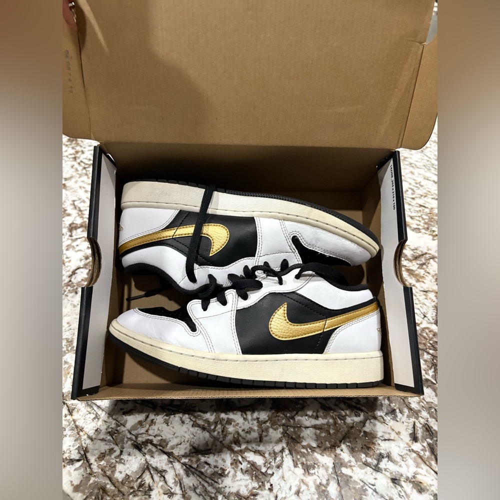 Air Jordan 1 Low. Black Gold and White Nike shoes.